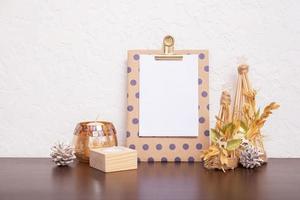 Mock up tablet with sheet paper and Christmas New Year decorations still life. Xmas text blank photo