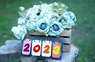 Beautiful colorful roses on the table for the festive New Year 2023 photo