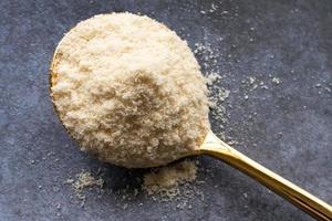 Whey Protein Powder on a Gold Spoon photo