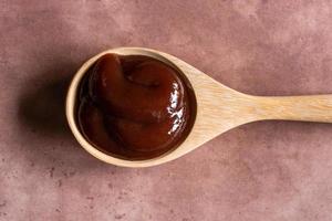 Barbecue Sauce on a Wood Spoon photo