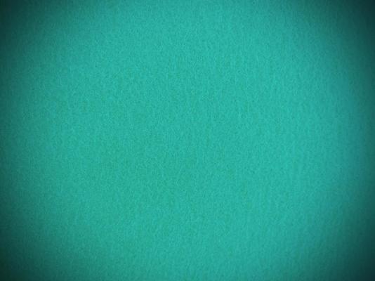 Felt dark green soft rough textile material background texture