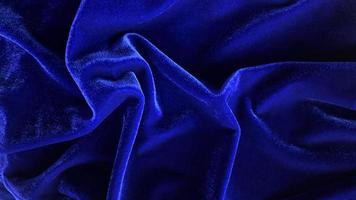 textura de tela de terciopelo azul utilizada como fondo. fondo de tela azul vacío de material textil suave y liso. hay espacio para el texto. foto