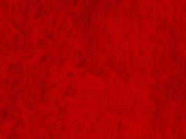 fondo de textura de lana limpia roja. lana de oveja natural ligera. algodón rojo sin costuras. textura de piel esponjosa para diseñadores el día de navidad. primer fragmento alfombra de lana roja.. foto