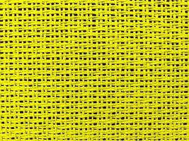 primer plano amarillo el está tejido en una red. textura de cuerda natura como fondo. Fotograma completo de patrón de cuerda estrechamente tejida. Con espacio para texto, para un fondo. foto