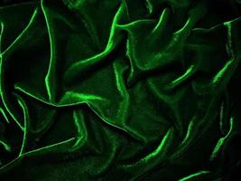 Green velvet fabric texture used as background. Empty green fabric background of soft and smooth textile material. There is space for text. photo