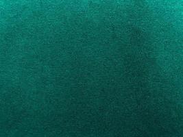 Dark green new velvet fabric texture used as background. Empty green fabric background of soft and smooth textile material. There is space for text.. photo