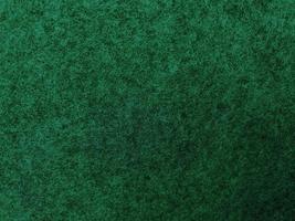 Felt dark green soft rough textile material background texture close up,poker table,tennis ball,table cloth. Empty green fabric background. photo