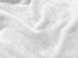 fondo de textura de lana limpia blanca. lana de oveja natural ligera. algodón blanco sin costuras. textura de piel esponjosa para diseñadores. fragmento de primer plano alfombra de lana blanca. foto