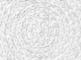 Round braided natural straw table mat texture as a white background. Full frame of tightly woven straw pattern.with space for text, for a background. photo
