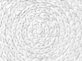 Round braided natural straw table mat texture as a white background. Full frame of tightly woven straw pattern.with space for text, for a background. photo