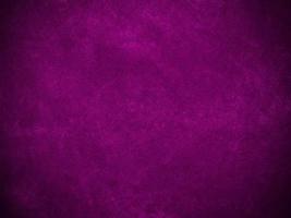 textura de tela de terciopelo morado claro utilizada como fondo. fondo de tela púrpura vacío de material textil suave y liso. hay espacio para el texto. foto