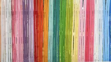 Rainbow Bamboo Wall In the bright concept of a long segmented bamboo wall painted in multi-colored Use it as a background or backdrop. photo