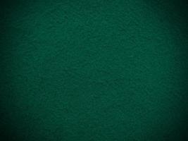 fieltro verde oscuro suave áspero material textil textura de fondo de cerca, mesa de póquer, pelota de tenis, mantel. fondo de tela blanca vacía. foto