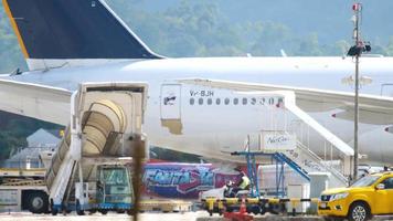 PHUKET, THAILAND DECEMBER 02, 2018 - Boeing 777 of Nordwind Airlines at Phuket airport terminal. Aircraft service before departure video