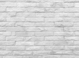 Seamless texture of white stone wall a rough surface, with space for text, for a background. photo