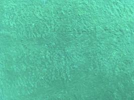 Seamless texture of ocean color cement wall a rough surface, with space for text, for a background. photo