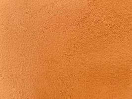 Seamless texture of orange cement wall a rough surface, with space for text, for a background. photo