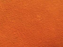 textura transparente de pared de cemento naranja una superficie rugosa, con espacio para texto, para un fondo. foto
