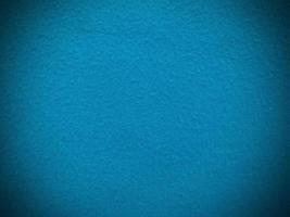 fieltro azul claro suave áspero material textil textura de fondo de cerca, mesa de póquer, pelota de tenis, mantel. fondo de tela azul claro vacío. foto