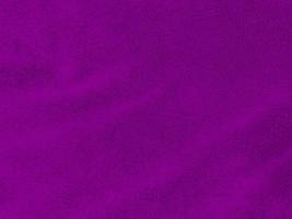 Purple clean wool texture background. light natural sheep wool. purple seamless cotton. texture of fluffy fur for designers. close-up fragment purple wool carpet. photo