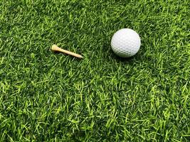 Golf ball close up on green grass on blurred beautiful landscape of golf  background.Concept international sport that rely on precision skills for health relaxation. photo