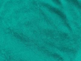 Dark green old velvet fabric texture used as background. Empty green fabric background of soft and smooth textile material. There is space for text... photo