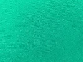Dark green old velvet fabric texture used as background. Empty green fabric background of soft and smooth textile material. There is space for text.. photo