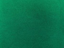 Dark green velvet fabric texture used as background. Empty green fabric background of soft and smooth textile material. There is space for text. photo