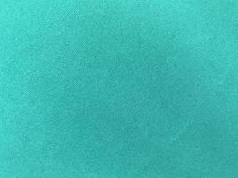 Dark green old velvet fabric texture used as background. Empty green fabric background of soft and smooth textile material. There is space for text.. photo