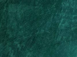 Dark green old velvet fabric texture used as background. Empty green fabric background of soft and smooth textile material. There is space for text.. photo