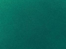 Dark green old velvet fabric texture used as background. Empty green fabric background of soft and smooth textile material. There is space for text... photo