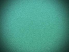 fieltro verde menta material textil áspero suave textura de fondo de cerca, mesa de póquer, pelota de tenis, mantel. fondo de tela de menta vacía. foto