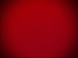 fieltro rojo suave áspero material textil textura de fondo de cerca, mesa de póquer, pelota de tenis, mantel. fondo de tela roja vacía. foto