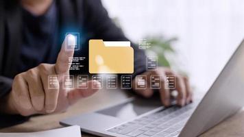 Businessman finger touch digital device, hud hologram with office document icons and binary. Storage of personal data information, online database. Concept of cloud service photo