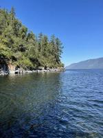 Rocky shore of lake Teletskoye in sunny day. Altai, Russia. photo