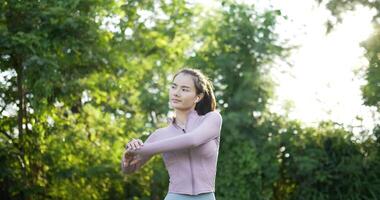 Side view of Happy asian young woman running and exercising in a park outdoors. Confident and powerful lady running with determination. Healthy, exercise, fitness and lifestyle concept. video