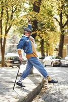 Happy stylish senior in fashionable clothes and in glasses have a walk and enjoying life photo