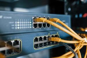 Close up view of internet equipment and cables in the server room photo