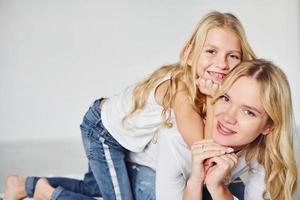 Mother with her daughter together in the studio with white background photo