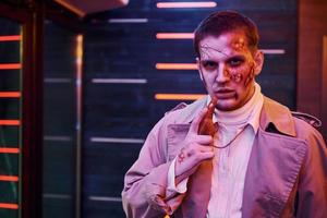 Portrait of man that is on the thematic halloween party in zombie makeup and costume photo
