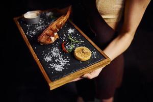 Top view of woman with food in modern restaurant photo