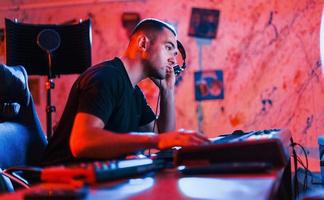 Sound engineer working and mixing music indoors in the studio photo