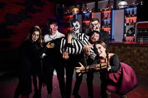 Friends is on the thematic halloween party in scary makeup and costumes photo