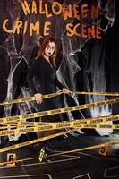 Crime scene wall. Portrait of woman that is on the thematic halloween party in scary makeup and costume photo