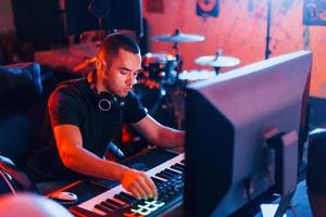 ingeniero de sonido trabajando y mezclando música en interiores en el estudio foto