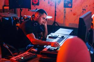 Sound engineer working and mixing music indoors in the studio photo