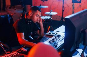 Sound engineer working and mixing music indoors in the studio photo