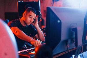 Sound engineer working and mixing music indoors in the studio photo