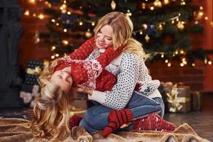 Mother and little girl having fun and celebrating christmas holidays photo