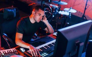 Sound engineer working and mixing music indoors in the studio photo